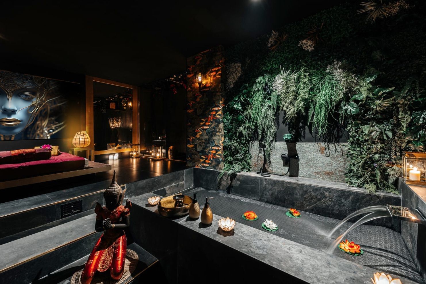 Luxurious spa interior with stone bathtub, greenery on walls, and decorative elements in dim lighting.